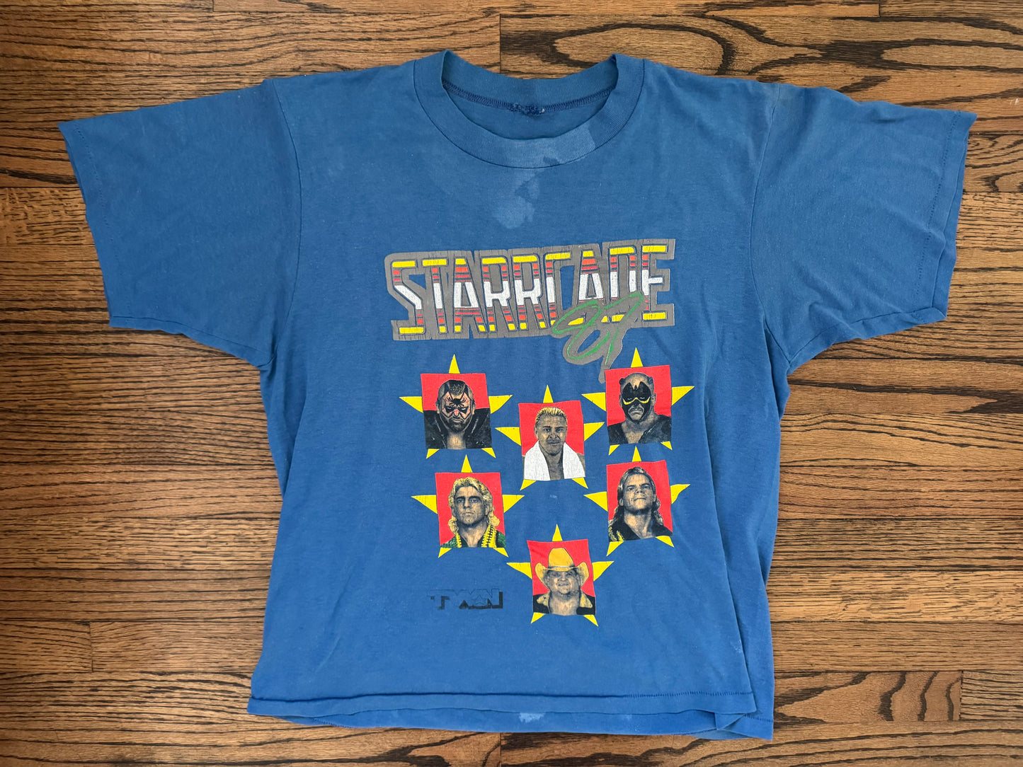 1987 NWA JCP STARRCADE shirt featuring The Road Warriors, “Rugged” Ronnie Garvin, “The Nature Boy” Ric Flair, “The American Dream” Dusty Rhodes and “the Total Package” lex luger