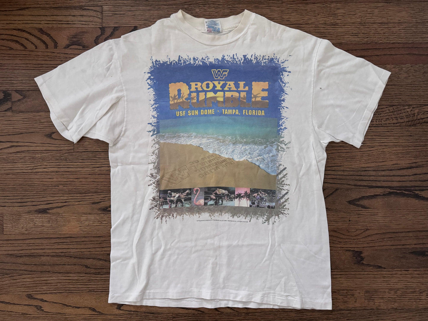 1995 WWF Royal Rumble shirt featuring a Flamingo, Bam Bam Bigelow, Crush’s 3rd gimmick in 3 years, Tatanka, Fatu, Sir Mo, Maybe the Smoking Gunns? Palm Trees, Lex Luger and Adam Bomb