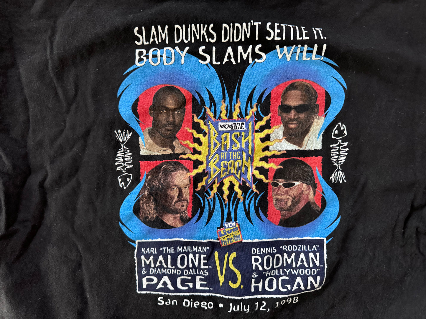 1998 WCW / n.W.o. Bash at the Beach event shirt featuring “Hollywood” Hulk Hogan, “Rodzilla” Dennis Rodman, “The Mailman” Karl Malone and Diamond Dallas Page

Size: XXL