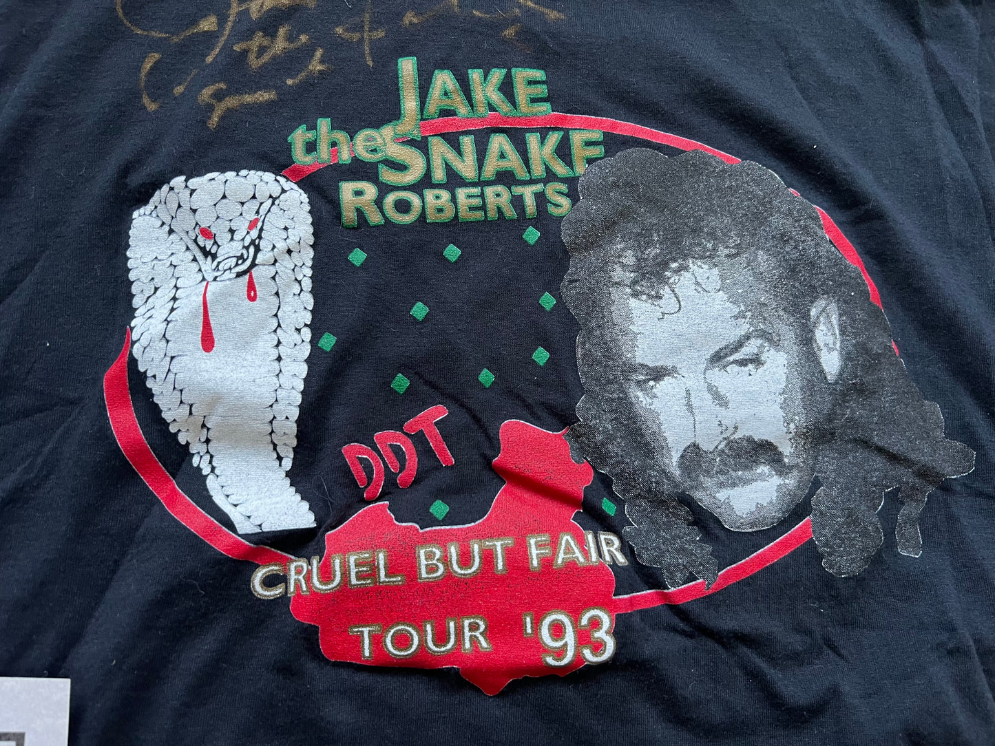 1993 Jake “The Snake” Roberts “Cruel But Fair” tour shirt signed by Jake and includes COA