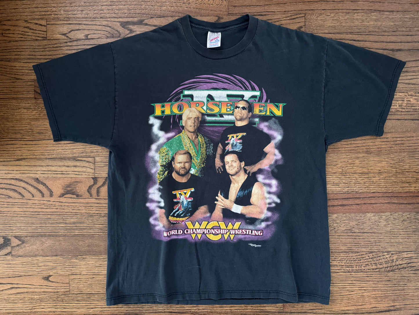 1996 WCW Four Horsemen shirt featuring “The Nature Boy” Ric Flair, Steve “Mongo” McMichael, “The Enforcer” Arn Anderson and “The Crippler” Chris Benoit

 